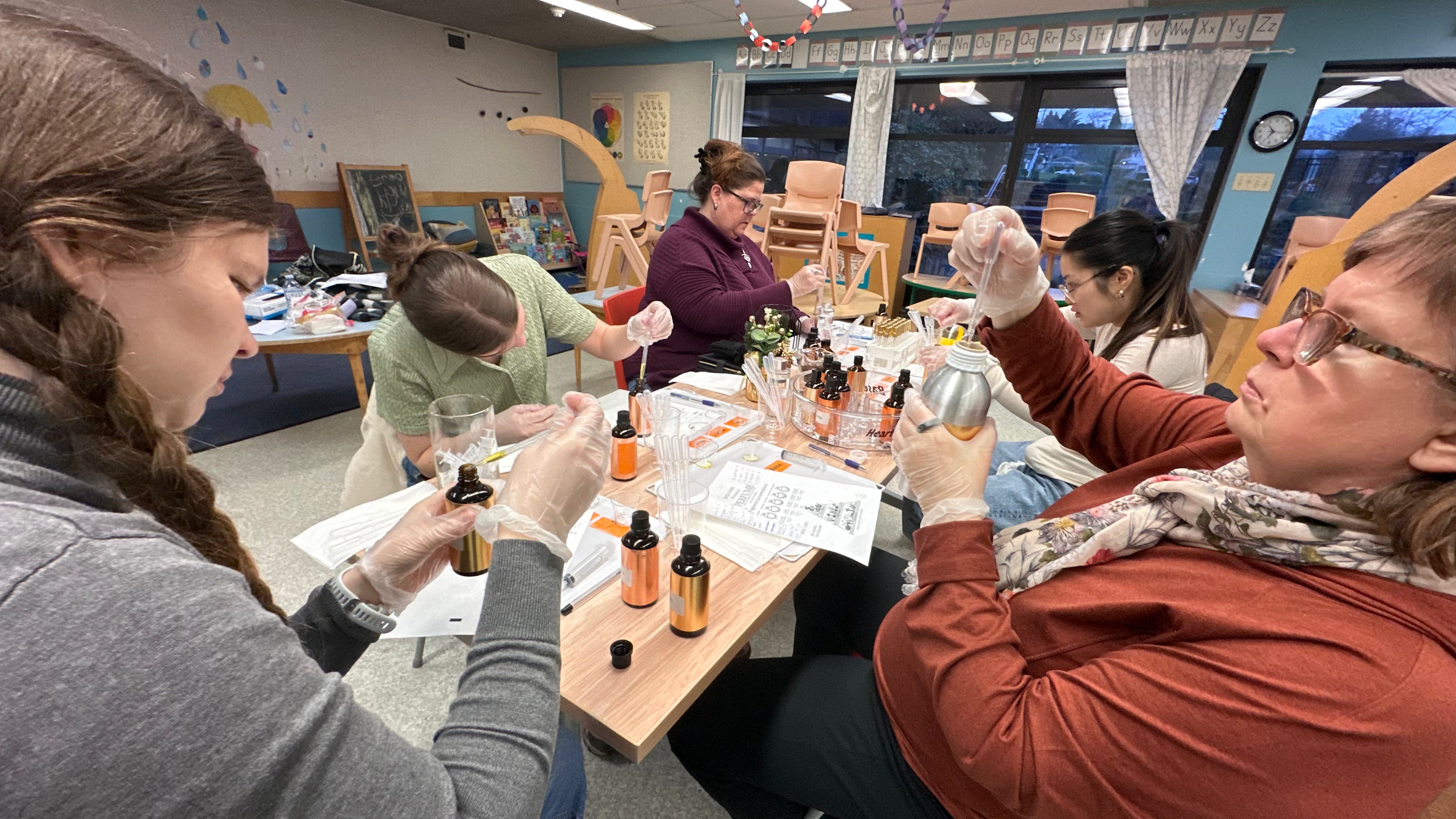 Team building events in Vancouver: colleagues blending their own perfumes, a creative team building activity at their office
