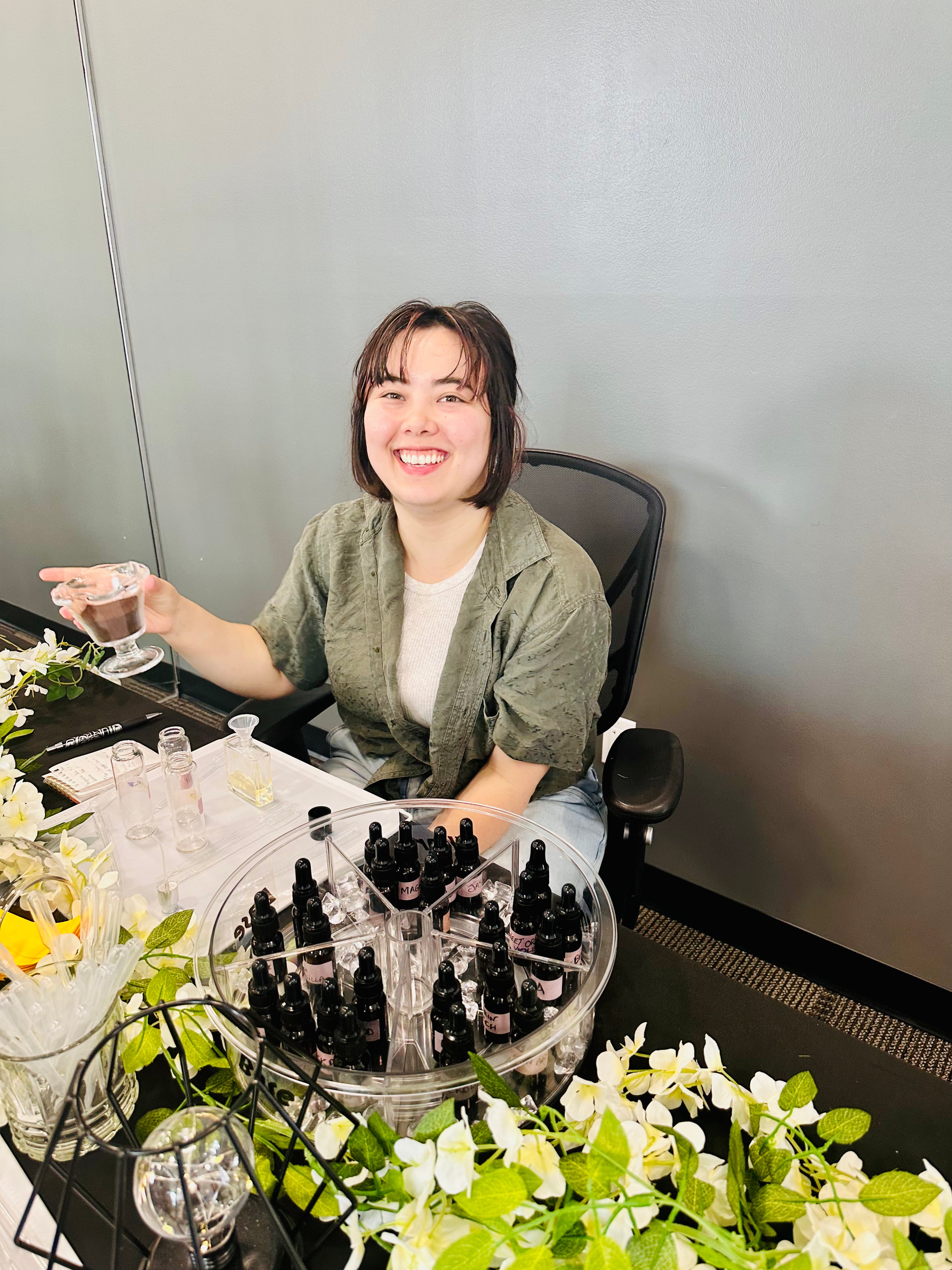Creative workshops in Vancouver: a guest clearing her nose with coffee beans between scents at a perfume making workshop
