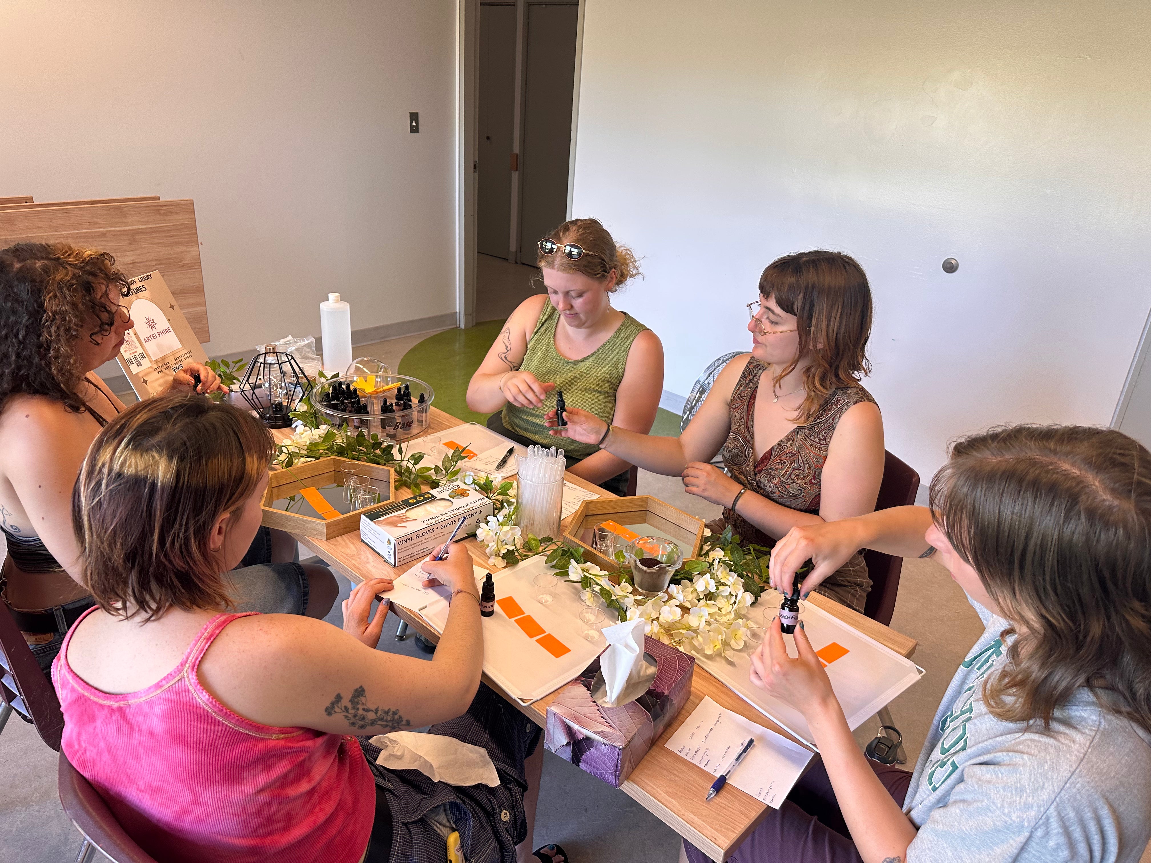 Group activities in Vancouver: five friends comparing natural perfume scents at an ARTEI PHIRE perfume making party