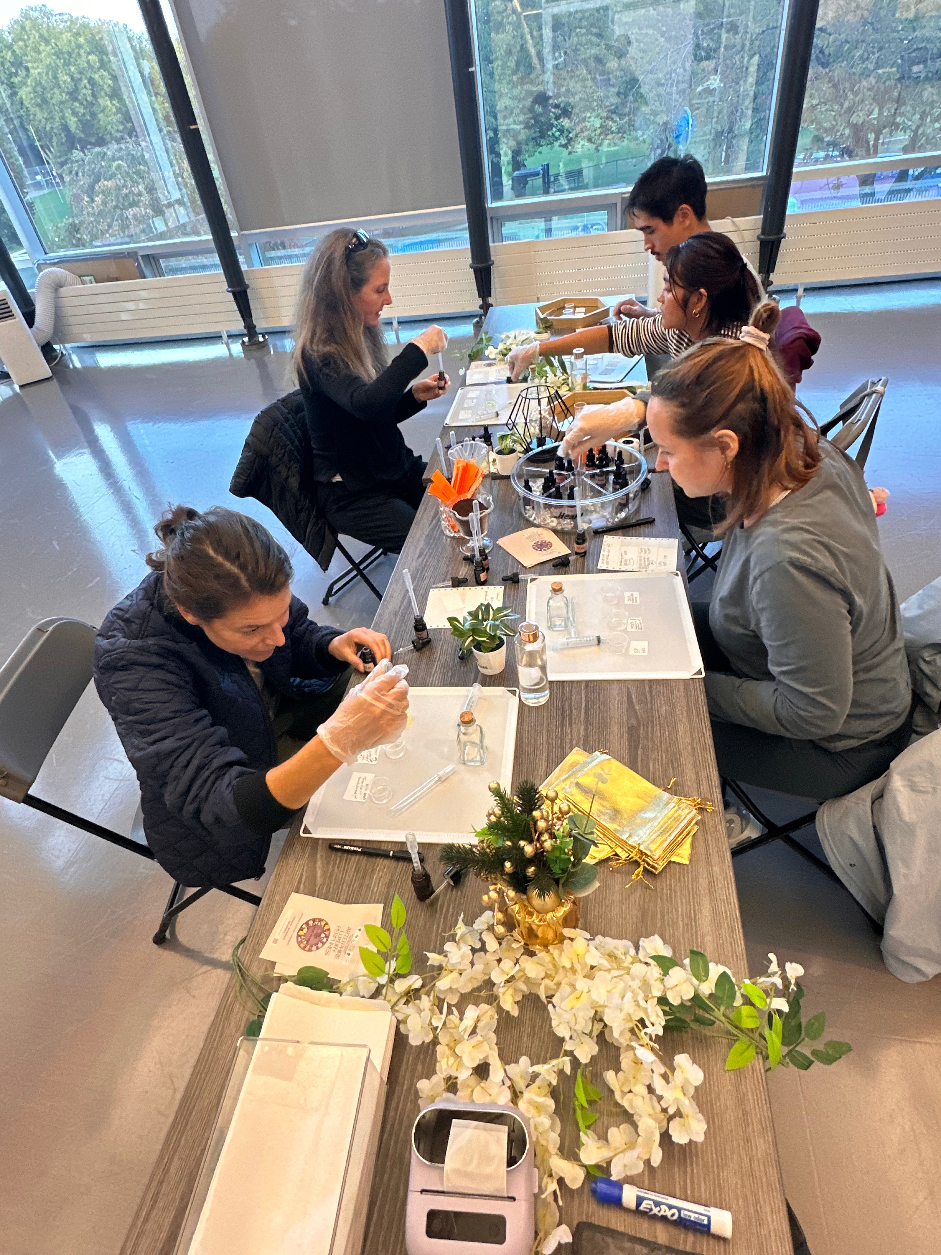 Team building perfume workshop in a Vancouver office — colleagues blending natural perfume with ARTEI PHIRE