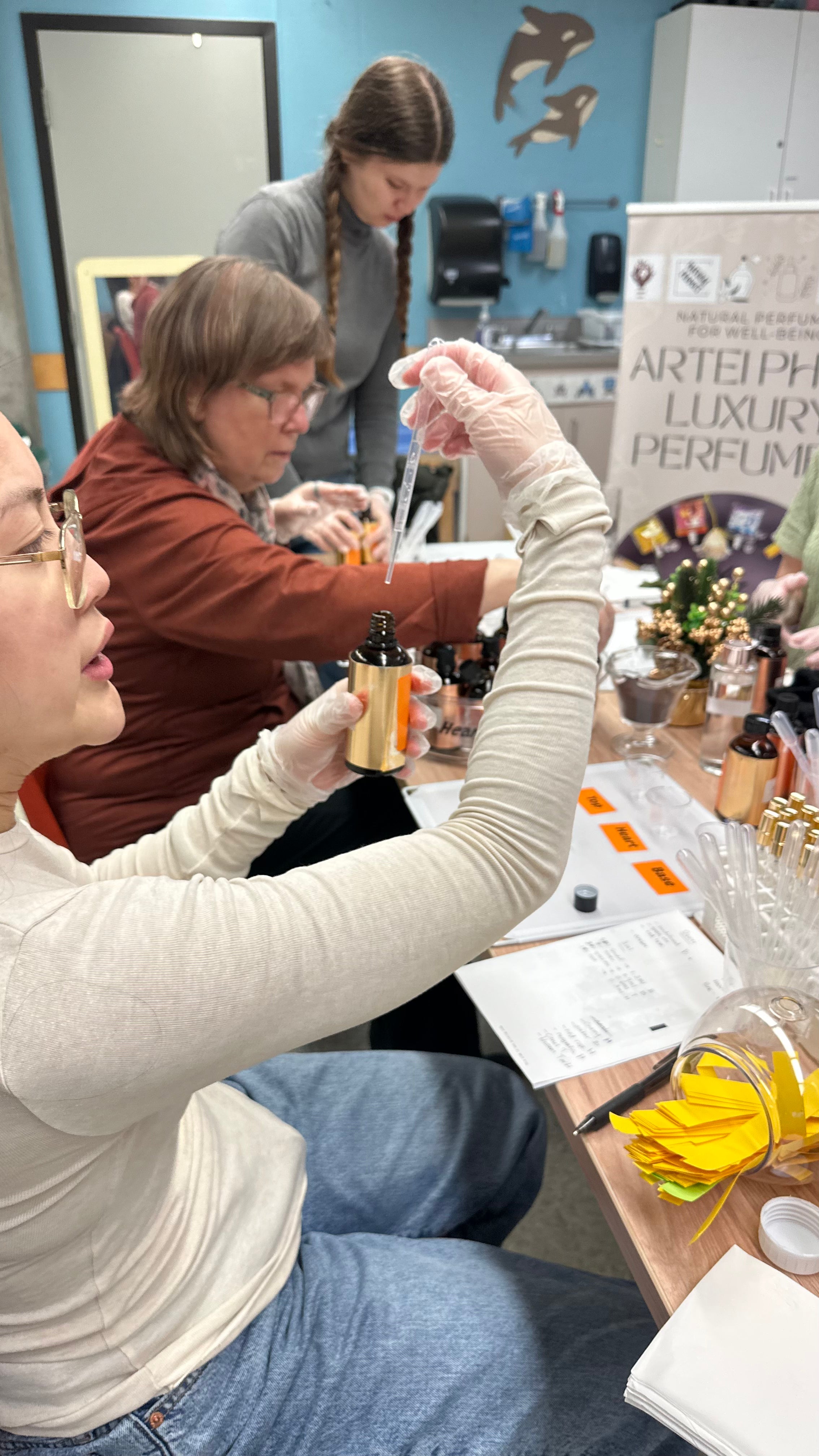 Create your own perfume in Vancouver: a guest measuring natural perfume oils at an ARTEI PHIRE perfume workshop